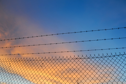 Prison / Jail yard surrounded by two layers of fence and barbed wire