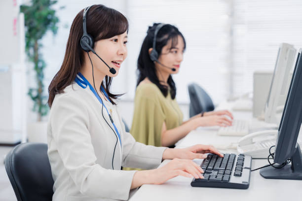 A woman responding to a customer at a call center stock photo