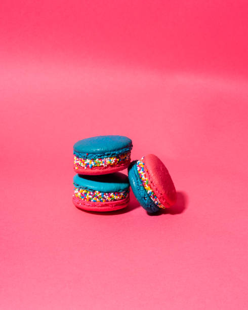 istock Vertical shot of macaroons isolated on pink background 1454822335
