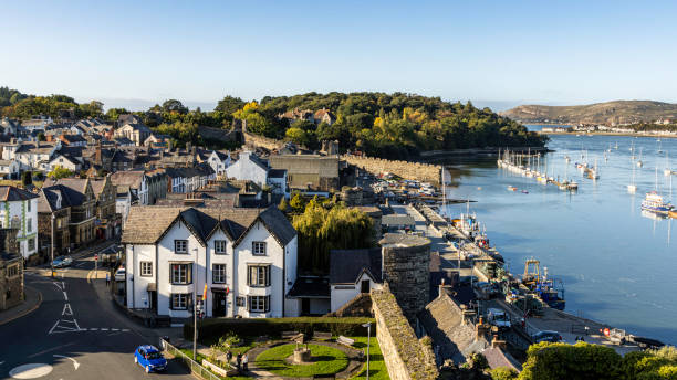 le port de conwy avec le mur du château de conwy. la ville de deganwy est de l’autre côté de la rivière. pays de galles, royaume-uni. - north wales photos et images de collection