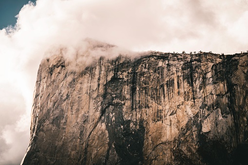 A landscape of El Capitan cliff Summit in California under cloudy sky