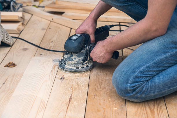 istock close up of a worker sanding wood planks with a grinder 1454824760