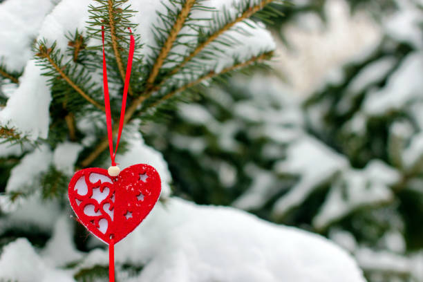 istock Heart-shaped Christmas tree decoration on spruce branch 1454829243