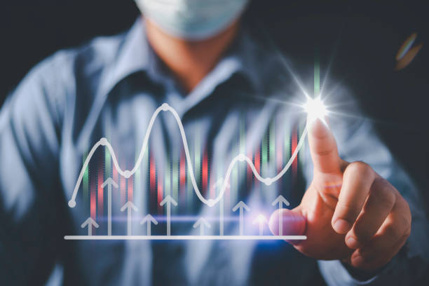 istock Businessman or trader is pointing a growing virtual hologram stock, planning analyze indicator and strategy buy and sell, Stock market, Business growth, progress or success concept. invest in trading. 1454829508