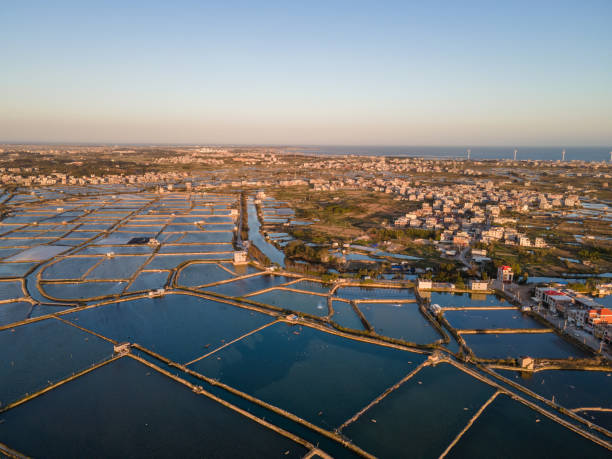 istock Seaside salt pans and small village at dusk 1454830728