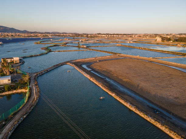 istock Seaside salt pans and small village at dusk 1454830847