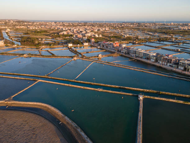 istock Seaside salt pans and small village at dusk 1454830855