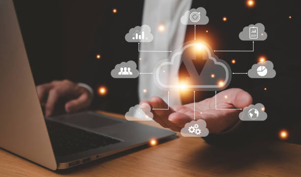 istock Selective focus at the icon with hand of businessman that holding cloud icon while who using internet and personal cloud storage to keep information and payment data, upload over the internet. 1454831090