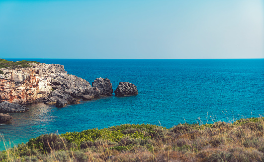 Corfu, Greece: Rock cliff at the Mediterranean on a sunny day near Limni beach.