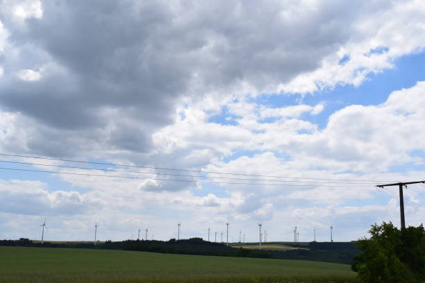 istock wide green landscape with storm clouds and wind power plants 1454832177