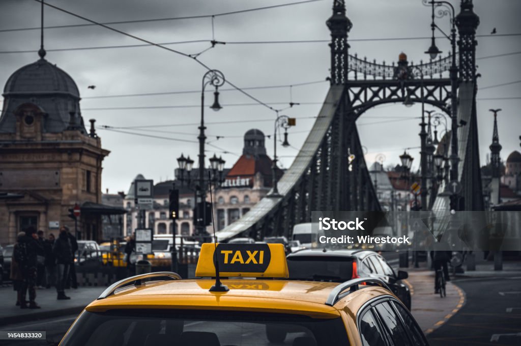 Yellow taxi cab car parked near the Liberty bridge in Budapest, Hungary A yellow taxi cab car parked near the Liberty bridge in Budapest, Hungary Architecture Stock Photo