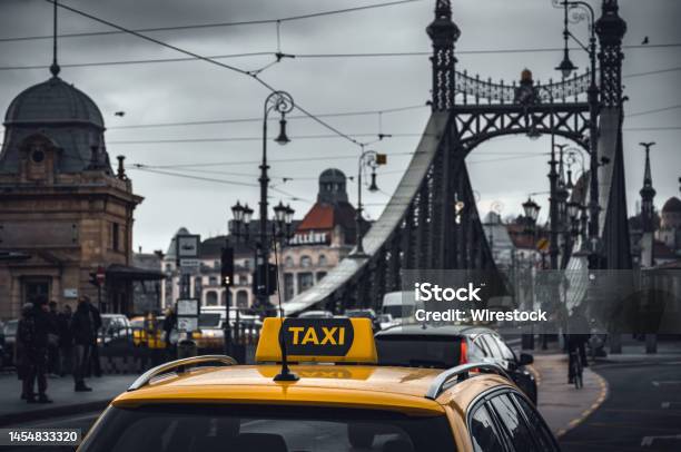 Yellow Taxi Cab Car Parked Near The Liberty Bridge In Budapest Hungary Stock Photo - Download Image Now