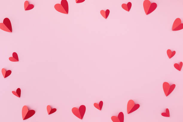 Valentine day greeting card or banner. Paper red hearts frame on pink background. stock photo