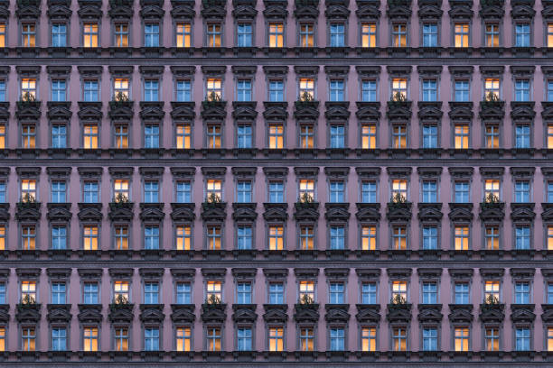 architectural pattern, beautiful pink facade of a berlin old building with illuminated windows