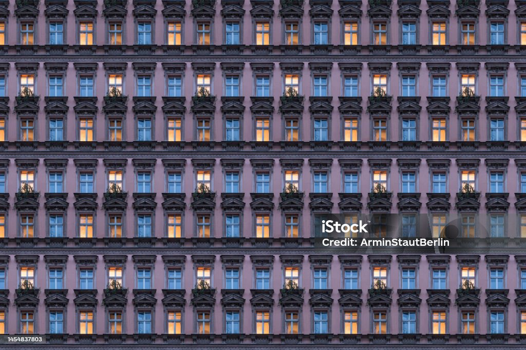 architectural pattern, beautiful pink facade of a berlin old building with illuminated windows Apartment Stock Photo