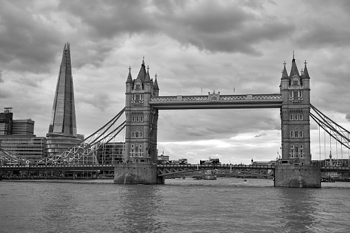 Tower Bridge and The Shard from the River Thames, low angle, black and white on a stormy day