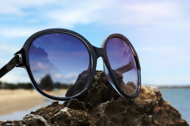 istock sunglasses on the rocky beach background 1454840275