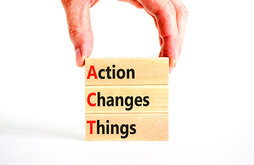 ACT action changes things symbol. Concept words ACT action changes things on wooden blocks on a beautiful white table white background. Business and ACT action changes things concept. Copy space.