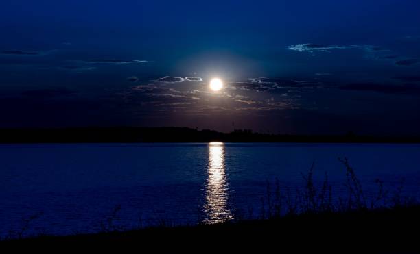 istock Moon in the sky with the reflection on the lake 1454845731