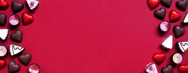 istock Valentines Day chocolate double border on a red paper banner background 1454845966