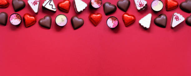 istock Valentines Day chocolate top border on a red paper banner background 1454846054