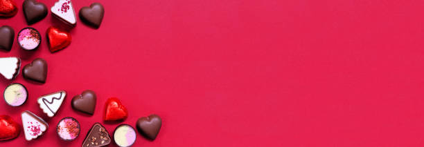 istock Valentines Day chocolate corner border on a red paper banner background 1454846720