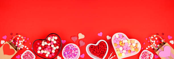 istock Valentines Day candy bottom border on a red banner background 1454846855