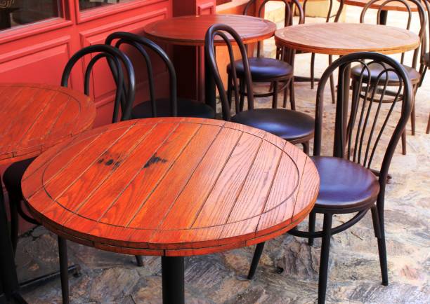 istock wood tables and black chairs set up for lunch outside cafe 1454849295