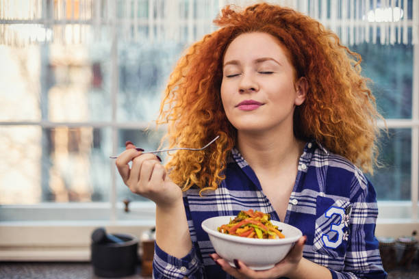 Woman eating a healthy vegetarian meal stock photo