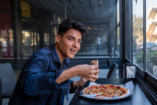 Young man enjoying pizza