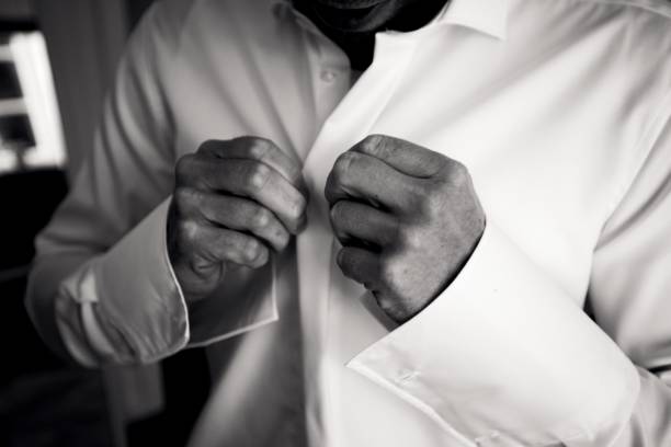 istock Grayscale of a handsome groom dressing up for wedding ceremony 1454853269