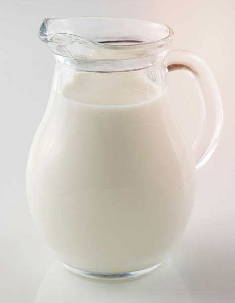 istock Glass jug of fresh milk isolated on white 1454854227