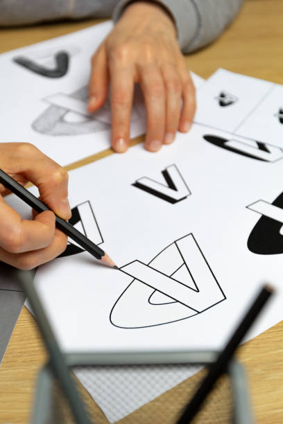 istock A graphic designer develops a logo for a brand. The illustrator draws sketches on paper. 1454854235