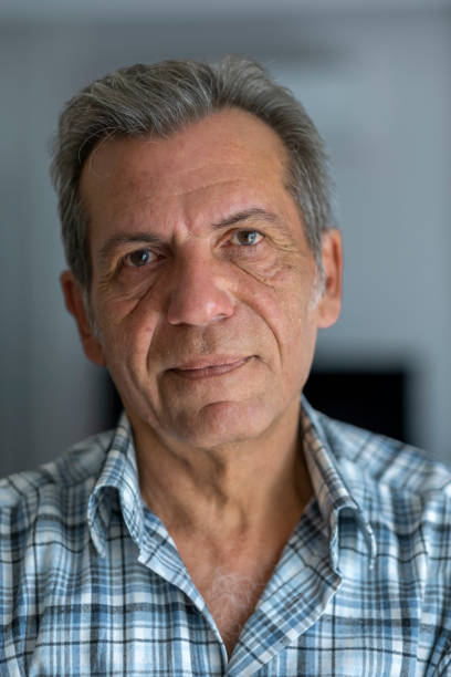 istock Happy old man looking at camera at home 1454854499