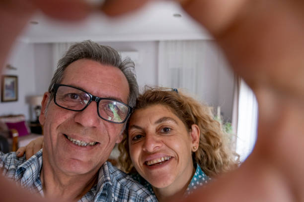 istock Happy elderly couple making selfie at home 1454854511