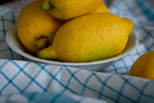 Fresh lemon fruits in a wooden box  on a wooden rustic table, top view