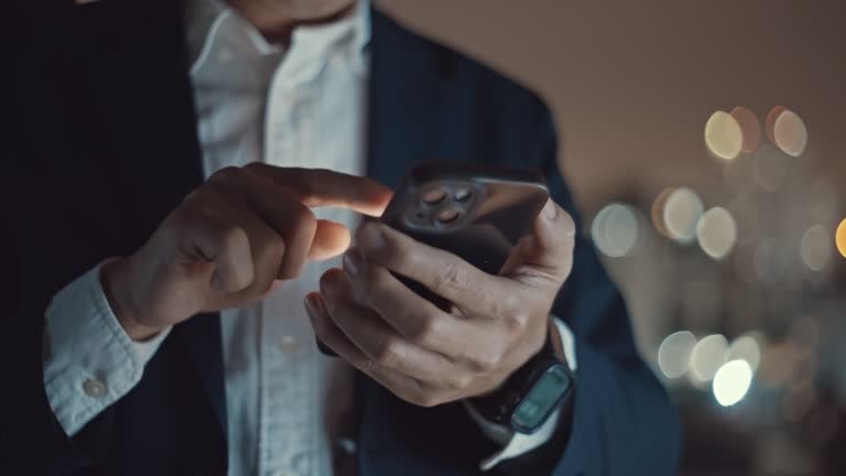 Businessman using smartphone at night,Close-up