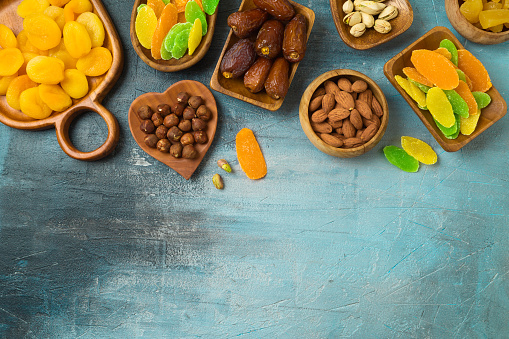 Dried dates, fruits and nuts on rustic background. tu bishvat holiday concept. Top view, flat lay.