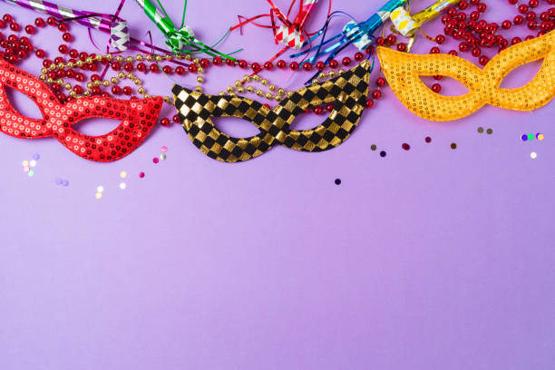 istock Mardi gras carnival background with carnival masks and party decorations. Top view, flat lay 1454859039