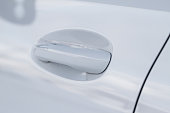 White car door handle. Keyless entry car door handle with touch sensor. Access button.