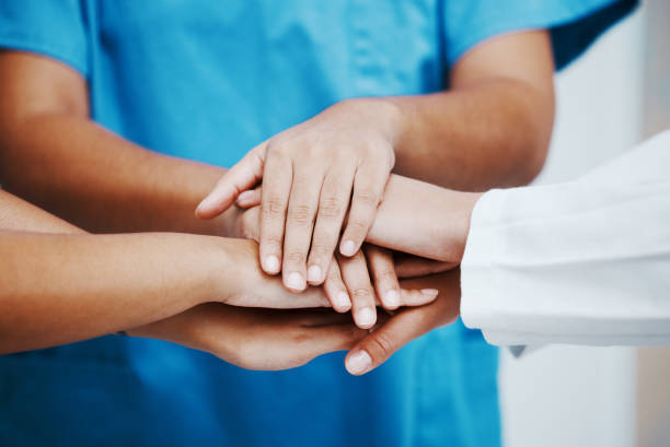 istock Healthcare, hands and team in support, trust or hope for unity, collaboration or cooperation at the hospital. Group hand of medical experts together in teamwork for agreement or meeting in solidarity 1454861330