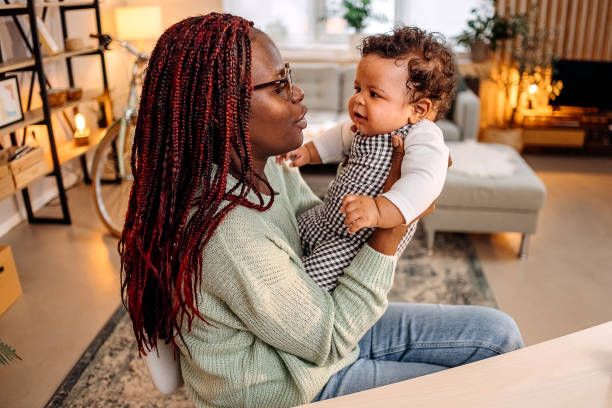 istock Mother with baby at home 1454862550