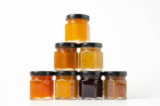istock Pyramid of jams. Different jam jars in piramid. Jam set. Different jam flavors on white background 1454863726