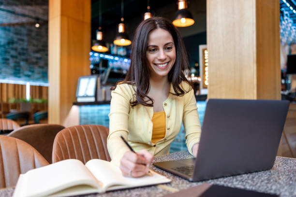 istock Young female student in modern cafe 1454864515