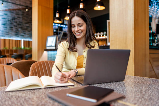istock Young female student in modern cafe 1454864520