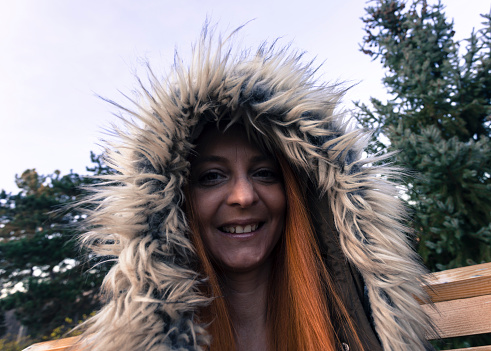 70 style portrait of woman wearing hood with fake fur on her head