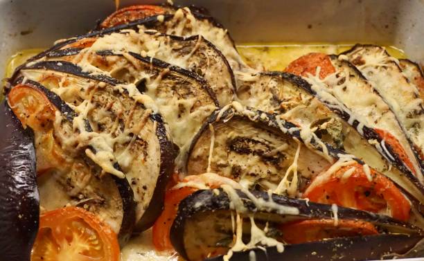 Italian dish with eggplant and cheese. Eggplant baked with cheese in the oven. Eggplant cut into a fan and baked with cheese in the oven. Italian delicious eggplant dish.