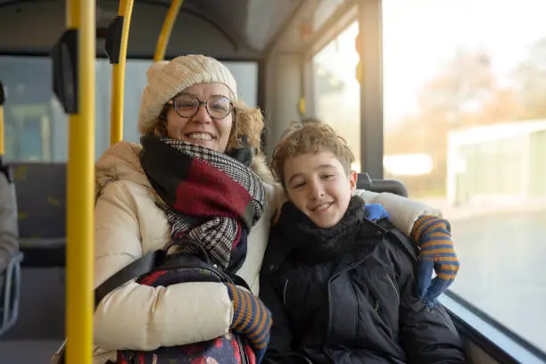 Photo of Portrait of a woman and her child seated in a public bus