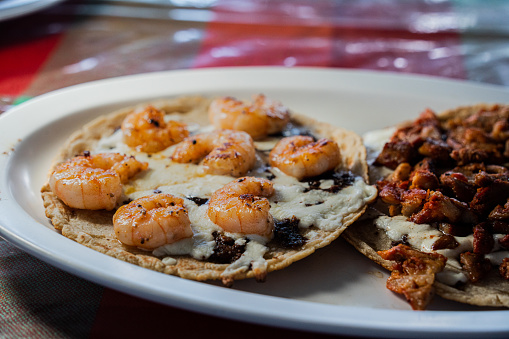 Gourmet Grilled Shrimp Taco with Sautéed Vegetables, Corn Tortilla and Melted Cheese at an Open Air Restaurant in Tijuana, Mexico