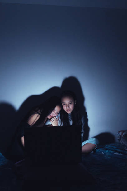 Young women at a sleepover watching very interesting and suspenseful movies. Young women at a sleepover watching movies. suspenseful stock pictures, royalty-free photos & images